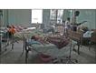 Women in beds in the busy maternity ward.