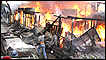 A man runs near a burning houses after a powerful earthquake in Padang, West Sumatra, Indonesia