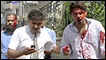 Injured men are seen near the site of the car bombing in Lahore, Pakistan on Wednesday, May 27, 2009