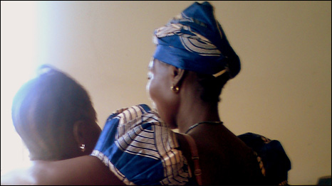 "MK (right of photo) greeted by an ex prisoner after her release"    (photo © AdvocAid 2011) 