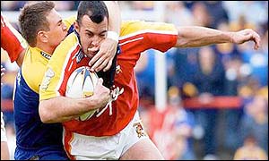 London's Wayne Evans is stopped by Kevin Sinfield