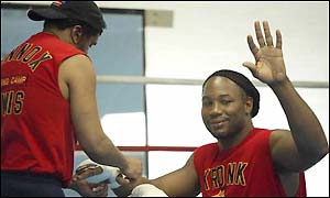 Lennox Lewis has his hands taped by trainer Emanuel Steward during a workout