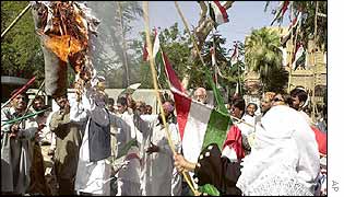 Pakistani protesters burn an effigy of the Indian PM in Karachi