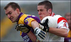 Tyrone's young defender Philip Jordan (right) in action