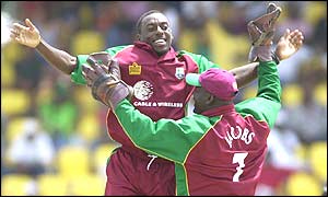 Pedro Collins and Ridley Jacobs celebrate the wicket of Craig McMillan  