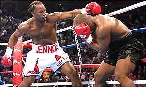 Lennox Lewis pins Mike Tyson to the ropes