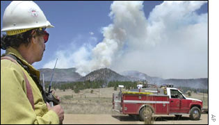A firefighter watches the wildfire outside Lake George, Colorado