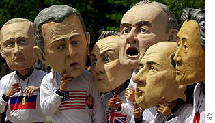 Papier mache heads representing six of the eight G-8 leaders attending next weeks summit in Kananaskis are worn by protesters at a rally in Calgary
