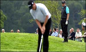 Colin Montgomerie watches as Soren Hansen holes another putt 