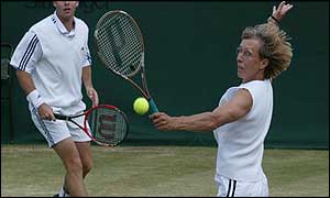 Navratilova volleys during her mixed doubles match against Kournikova and Bjorkman