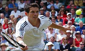 Tim Henman stretches to make a forehand volley