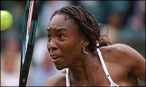 Venus Williams plays a backhand volley against Justine Henin