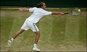 Xavier Malisse stretches for a backhand in his semi-final