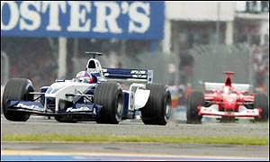 Juan Pablo Montoya held  off the Ferrari challenge of Michael Schumacher until lap 16