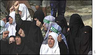 Women supporters of militant group Hamas chant slogans at the site of Tuesday's air strike