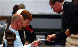 Holly's parents Nicola and Kevin Wells  and vicar Tim Alban Jones