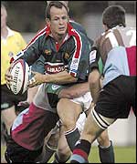 Austin Healey is wrapped up by Harlequins