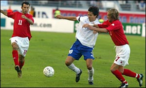 Ryan Giggs and Robbie Savage put Finalnd's Jari Litmanen under pressure