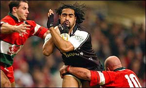 New Zealand's Henry  Faa'fili is tackled by the Welsh defence