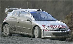 Marcus Gronholm's Peugeot leads Subaru's Petter Solberg and the Ford of Markko Martin