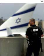 Policeman stands in front of El Al airplane