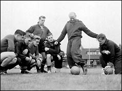 Sir Matt Busby (centre, standing)  with players in 1956