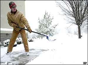 Man clearing snow from the pavement in Bella Vista,  Arkansas