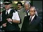 Diplomats flanked by armed police