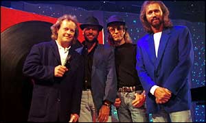 Bruno Brookes with the Bee Gees, Maurice, Robin and Barry Gibb after performing the song How Do I Fall In Love Part 1 on Top of the Pops  in 1994