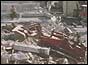 A digger clears rubble