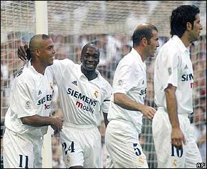 Real Madrid striker Ronaldo is mobbed after scoring his first goal