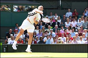 Andre Agassi serves during his game with  Younes El Aynaoui 