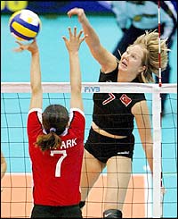 Turkey's Natalia Hanikoglu spikes the ball over Park Mee-Kyung of South Korea during the final round match in the World Cup women's volleyball tournament in Osaka