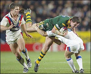 Steve Simpson of Australia is tackled by Terry Newton of Great Britain
