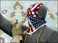 Soldier puttnig flag on statue
