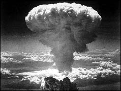 A mushroom cloud rising into the air after the atom bomb was dropped on Nagasaki