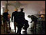 Firemen silhouetted at top of escalator