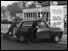 Two men push car to garage - London, 1973