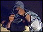 John Simpson donning his burqa