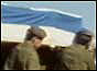 Soldiers bearing coffing on shoulders