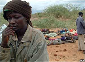 Man in front of dead bodies