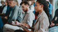 Conference audience taking notes