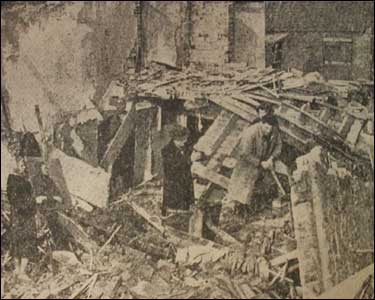 Survivors look around the rubble at Vicars Point, near Skegness.