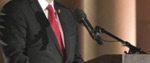 A speaker at a microphone