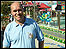 BBC Radio Manchester reporter Ian Cheeseman in front of a funfair ride in Hamburg