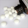 Tablets spilling from a medication bottle