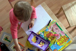 Image: a child colouring in
