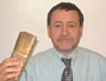 Russ Palmer holding the pay and service book that his great great grandfather, Daniel Hannibal, carried through the Crimean War
