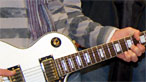 Hand playing electric guitar