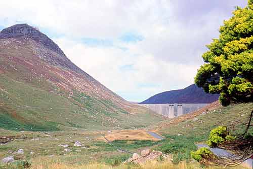 A view of the Ben Crom Dam wall with the steep head of Ben Crom itself to the left.